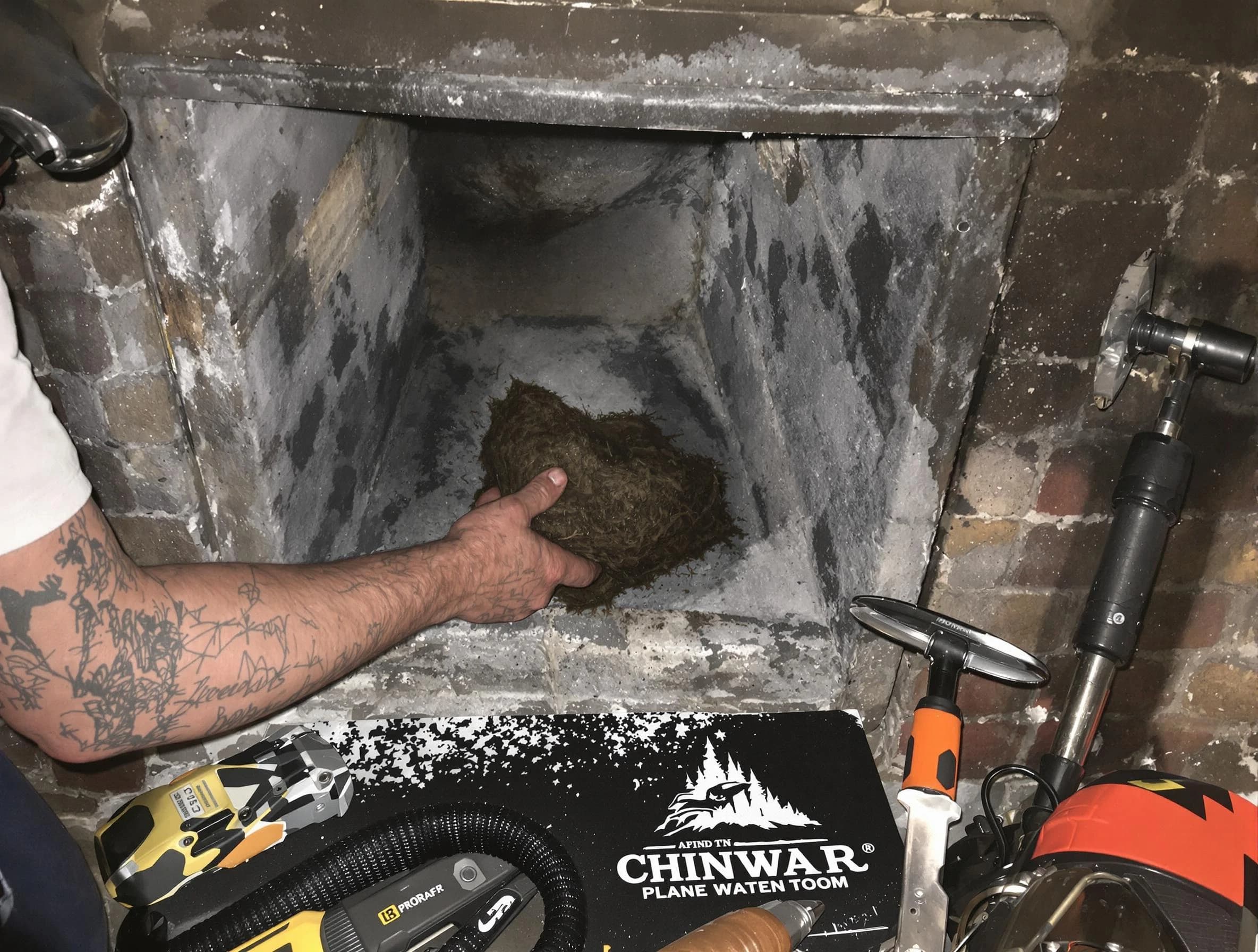 Arlington Chimney Sweep safely removing debris and screening chimney in Arlington, MA